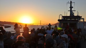 people on a cruise looking at a sunset